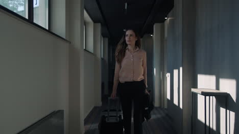 business woman walking at hotel corridor. businesswoman arriving in hotel