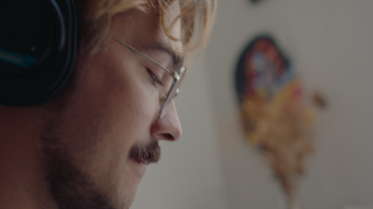 Man Recording Music at Home and Using Synthesizer