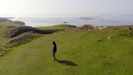 Beautiful-scene-of-a-hiker-walking-on-cliff-edge