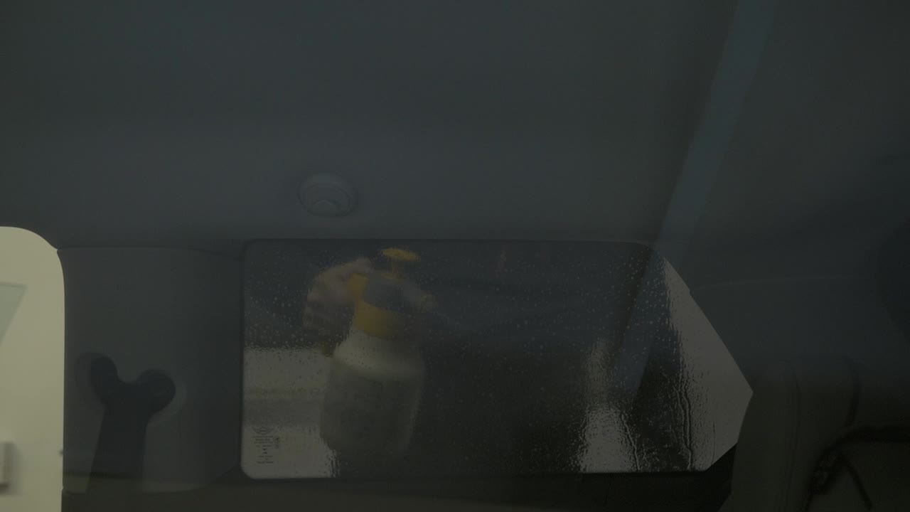 Car side window tinting foil process. Spraying tinting foil