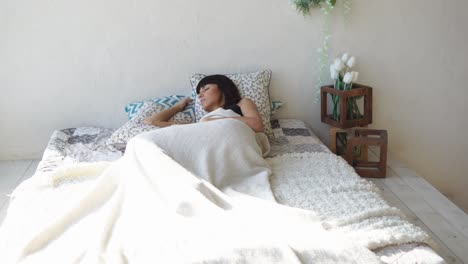 woman sleeping in a cozy bedroom