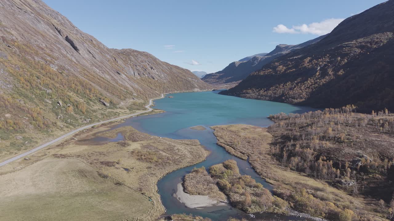 Backward flying drone footage showing beautiful glacier lake in Jotunheimen National Park in Norway