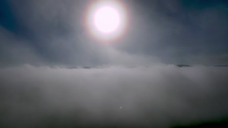 AERIAL-PULLOUT-THROUGH-CLOUDS-NEAR-NORTH-WILKESBORO-NC,-NORTH-CAROLINA