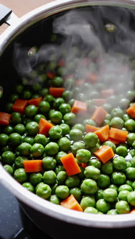 cooking peas and carrots in a pot