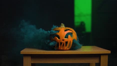 very thick blue smoke inside carved pumpkin coming out in slow-motion