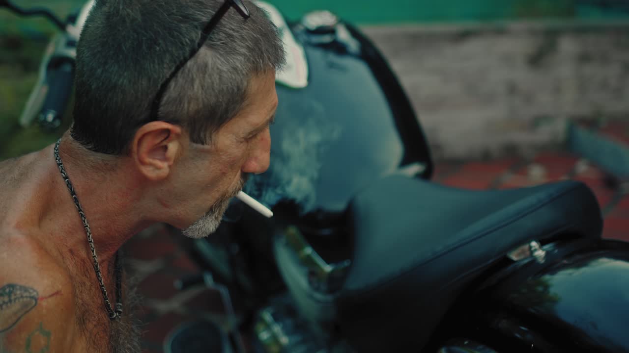 Older man repairing his motorcycle