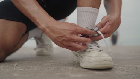 person tying their running shoes