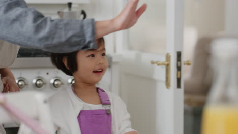 happy asian family dancing in kitchen children having fun dance with mother and father enjoying exciting weekend at home 4k footage