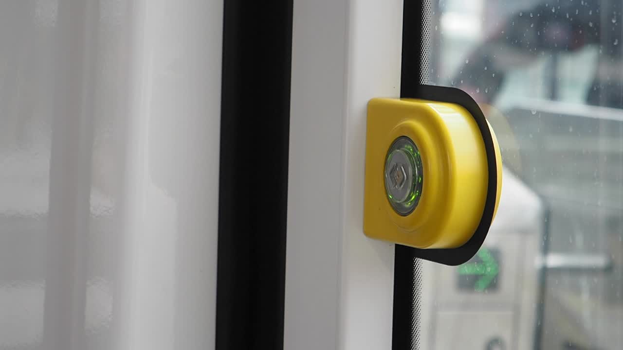 Yellow button on a public transportation door