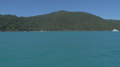 Turquoise-Blue-Waters-Of-Sawmill-Bay-Beach-Under-Clear-Blue-Sky-In-Summer