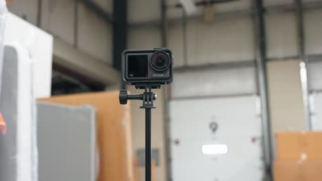 dji action 4 camera on a pole selfie stick recording in an industrial environment
