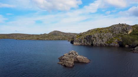 Aerial-dolly-above-stunning-granite-exposed-rocky-islands-in-lake-of-spain