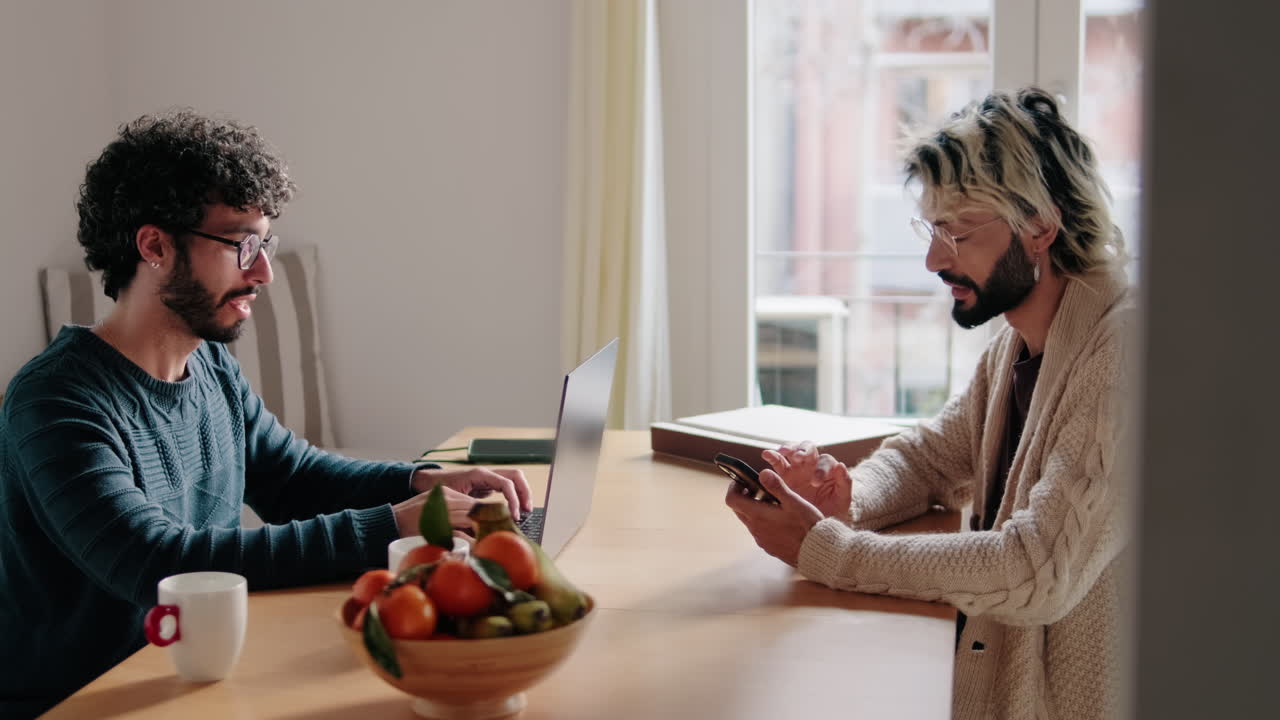 Gay Couple Working From Home at Table