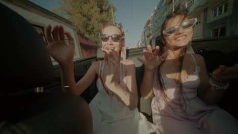 two women enjoying a convertible ride