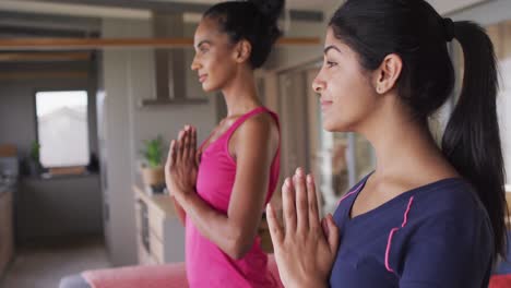 video of happy diverse women practicing yoga at home