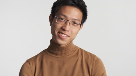 asian man in eyeglasses looking at the camera.