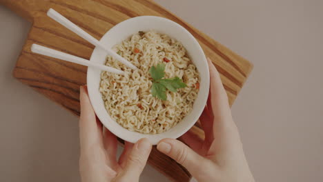 instant noodles in a bowl with chopsticks