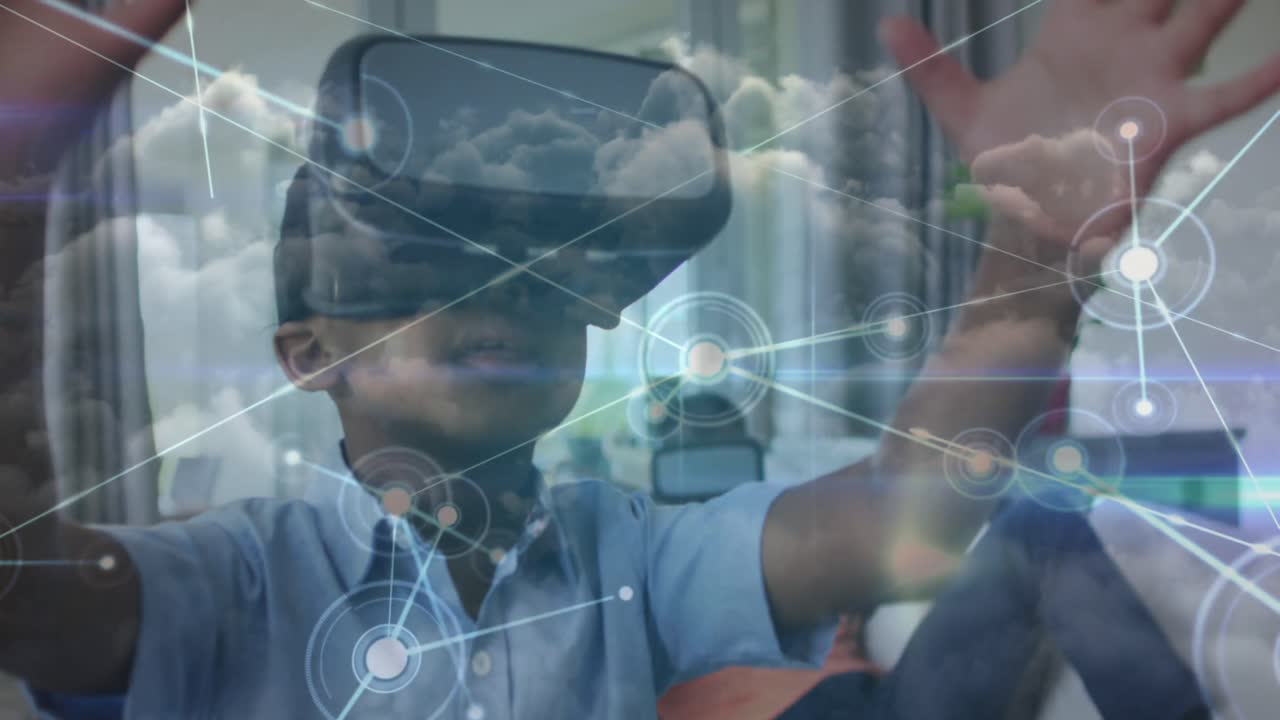 Animation of network of connections over happy african american boy wearing vr headset