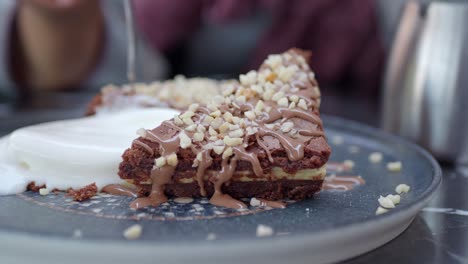slice of chocolate cake with nuts and whipped cream