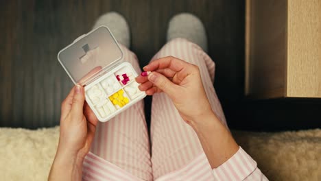 woman taking medication in bed