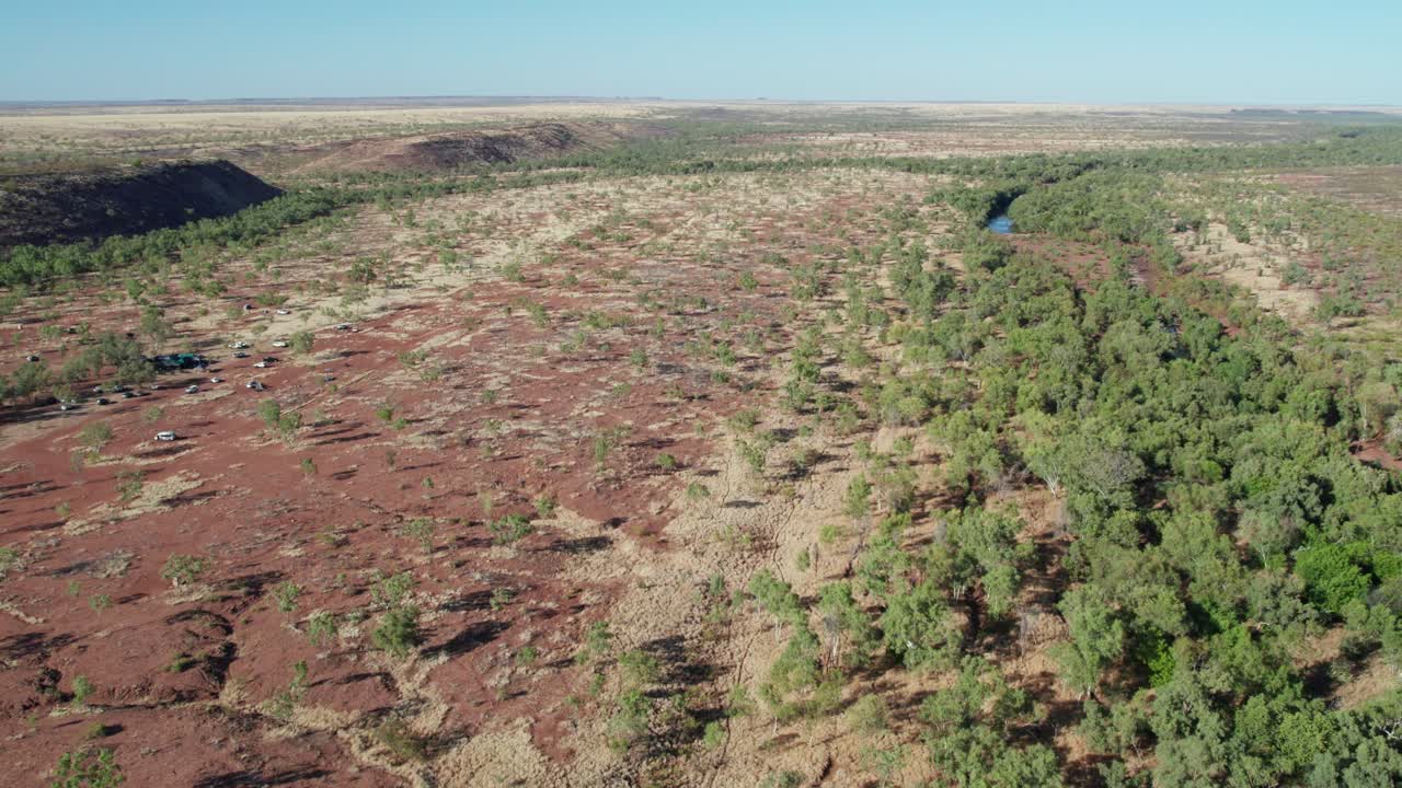 Sideways aerial view of the Victoria River and landscape near Kalkarindji, Gurindji, Northern Territory, Australia, August 2022.