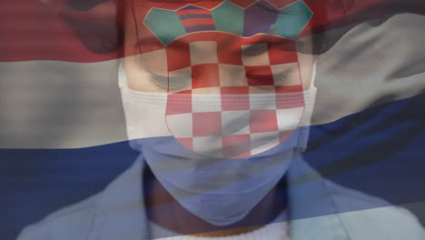 animation of flag of croatia waving over woman wearing face mask during covid 19 pandemic