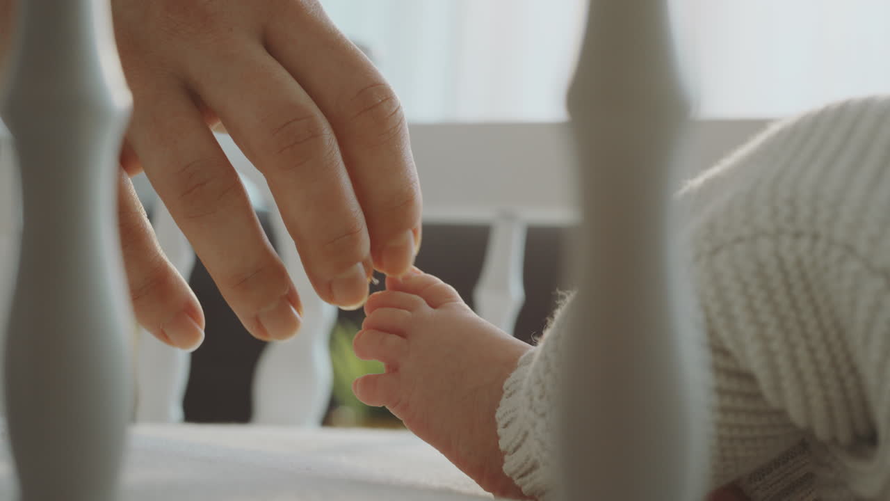 Parent Touching Baby's Foot
