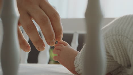 parent touching baby's foot