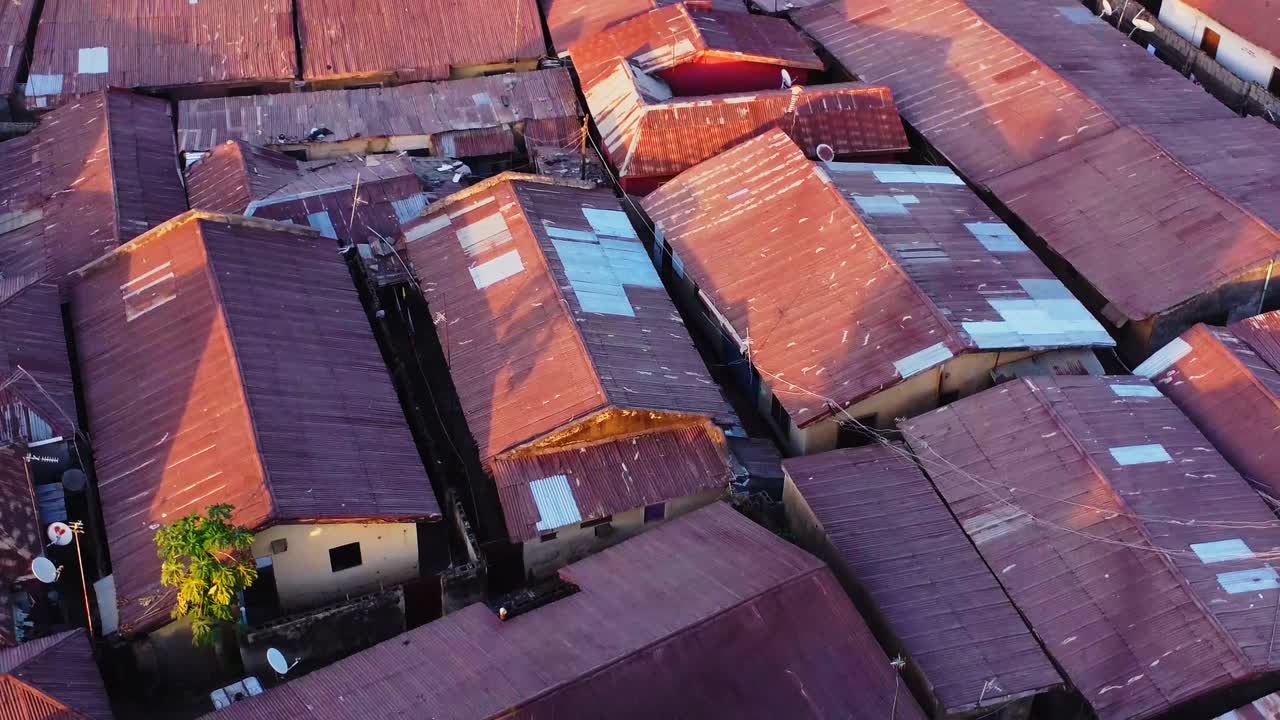 Beautiful aerial orbit of metal roofs on the homes of slums in Nigeria, Africa