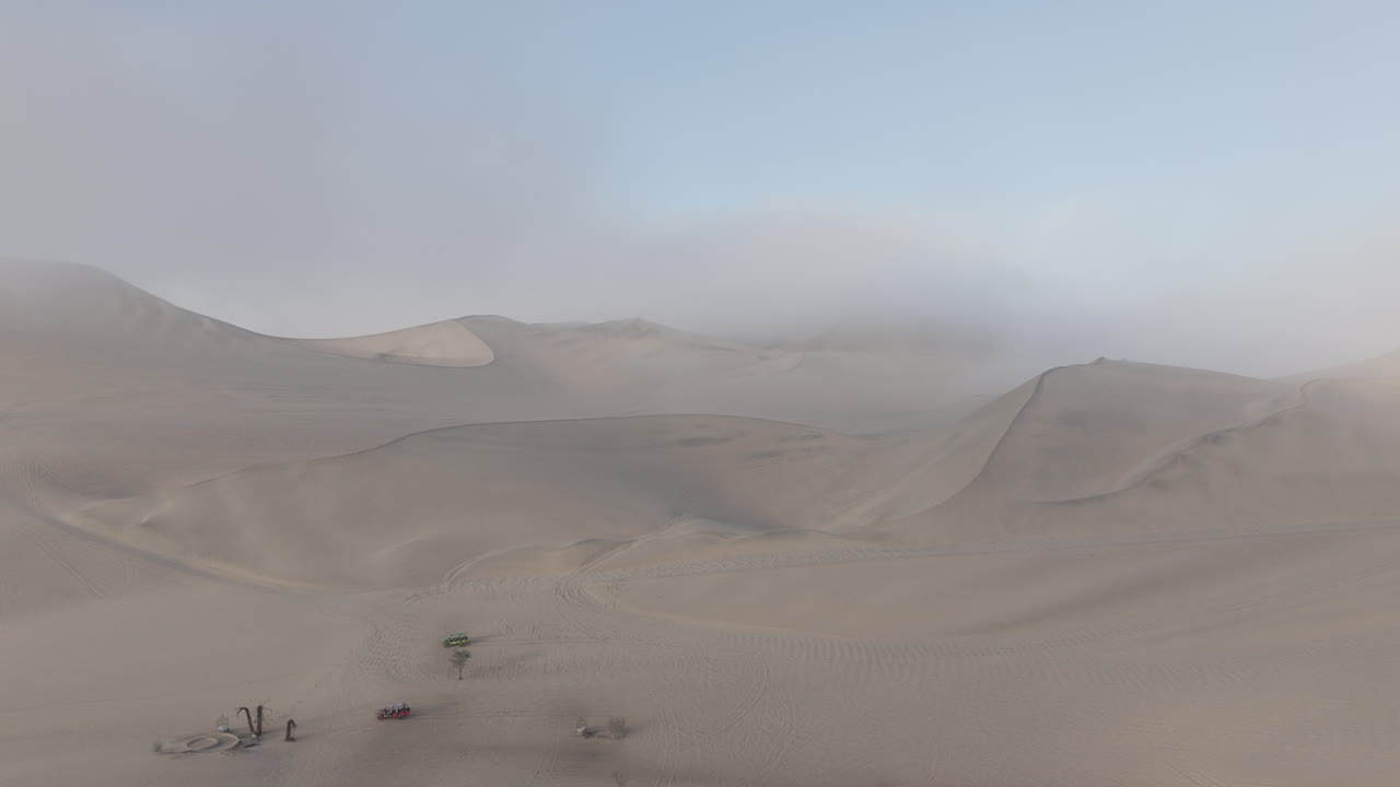 Drone shot near Huacachina Peru behind the dunes on a cloudy day during the mist in the morning LOG