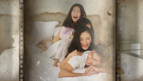 cheerful family of four lying over each other in bed