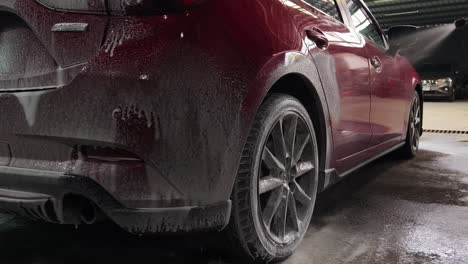 red car getting washed with foam