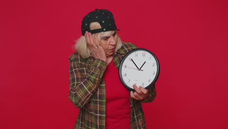 confused senior woman with anxiety checking time on clock running late to work, being delay deadline