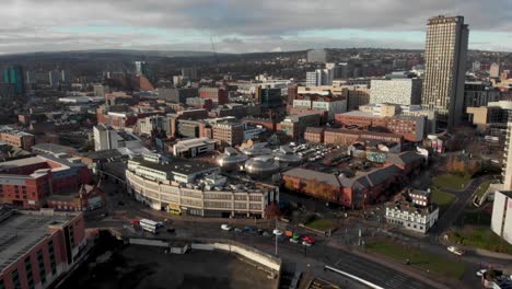 Drone-shot-above-the-city-of-Sheffield,-panning-over-the-Train-Station,-Sheffield-Hallam,-Park-Hill-and-more