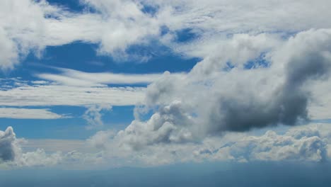 aerial dreamy cloudscape, fluffy cumulus, wispy cirrus clouds flow in sky