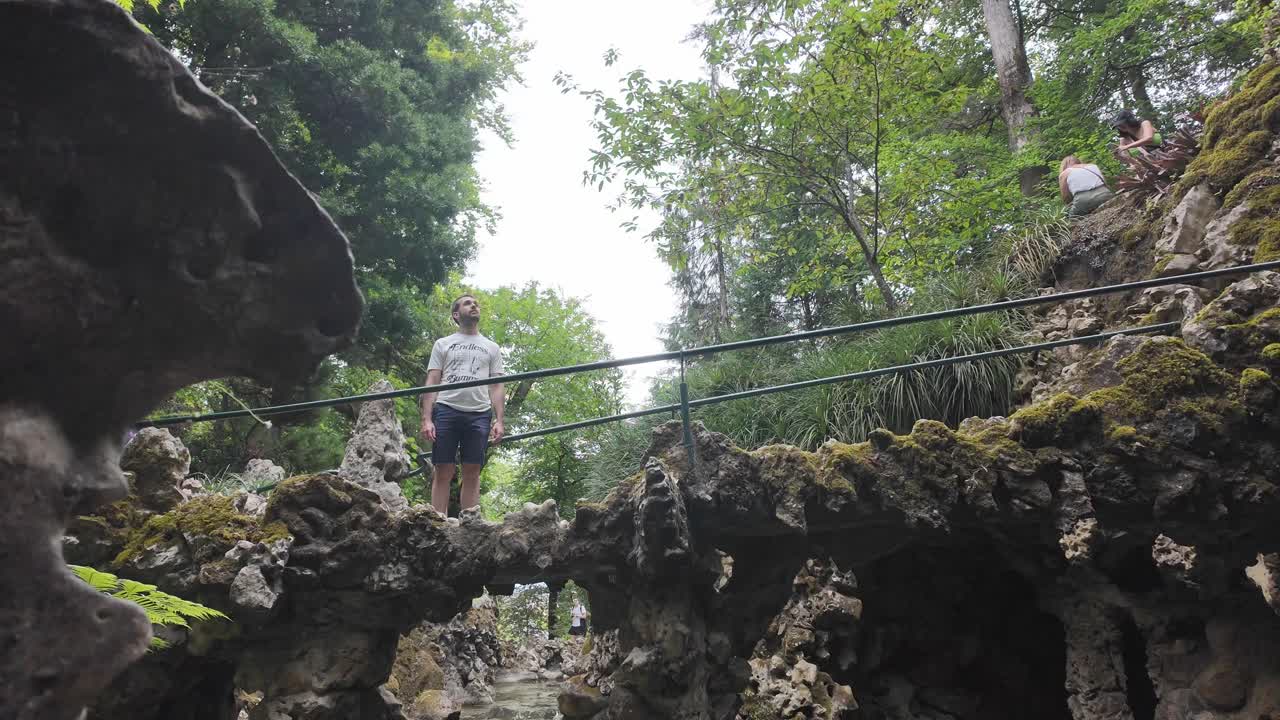 Water trickling down a moss-covered rock formation at Quinta da Regaleira, Sintra