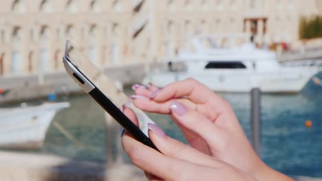 Hands-With-The-Tablet-On-The-Background-Of-Yachts