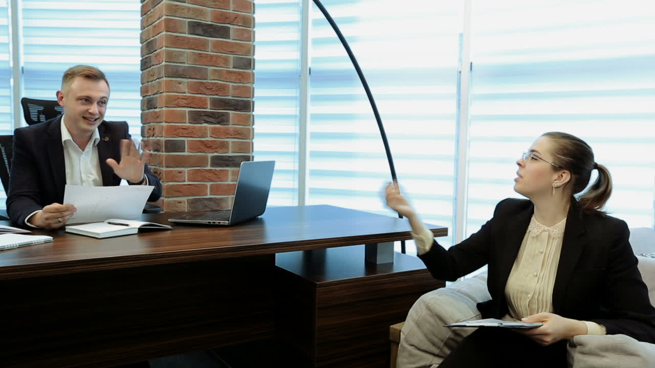 Business Woman Getting Direction From Her Boss. Business woman and man colleagues working in office