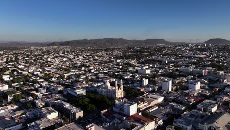 cathedral in culiacan rosales, golden hour in sinaloa, mexico - orbit, aerial view