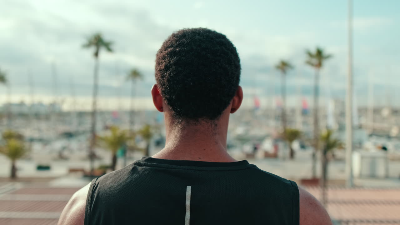 Young Man in Black Tank Top at Marina