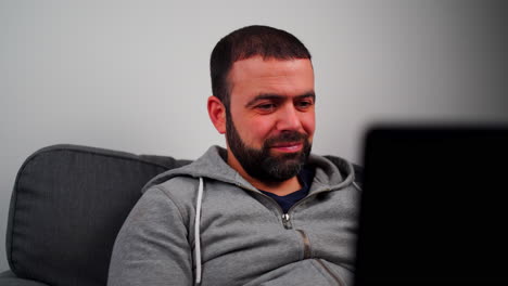 Man-Working-On-Laptop-In-The-Living-Room---Close-Up