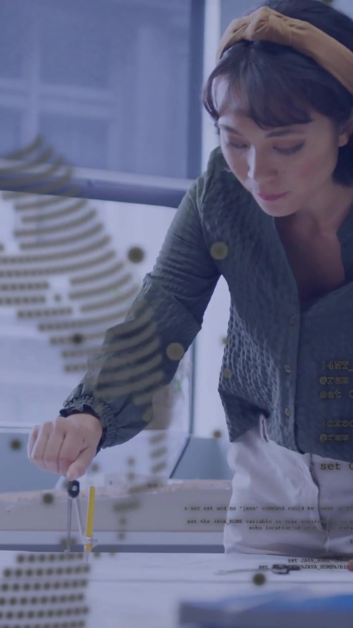 Vertical video: Designer placing compass drawing circles on paper while checking under dot overlay