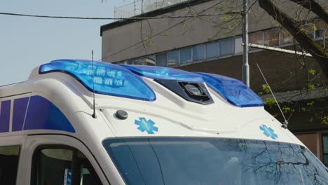 blue flashing siren on roof of ambulance car