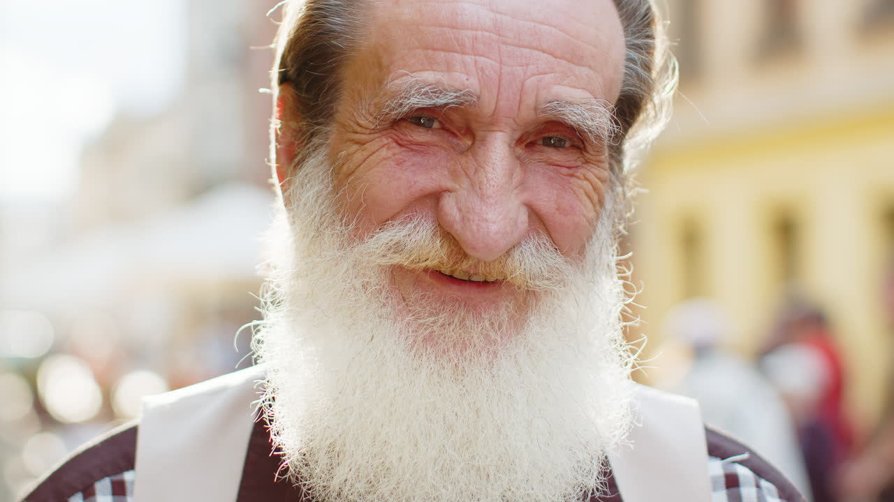 Happy mature old man smiling looking away dreaming resting good news feel satisfied in city street