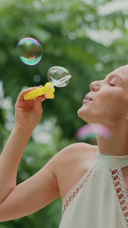 woman blowing bubbles in a park