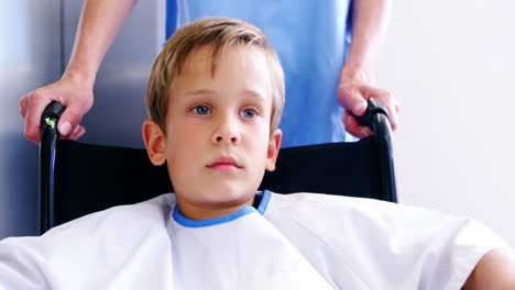 nurse pushing boy in wheelchair