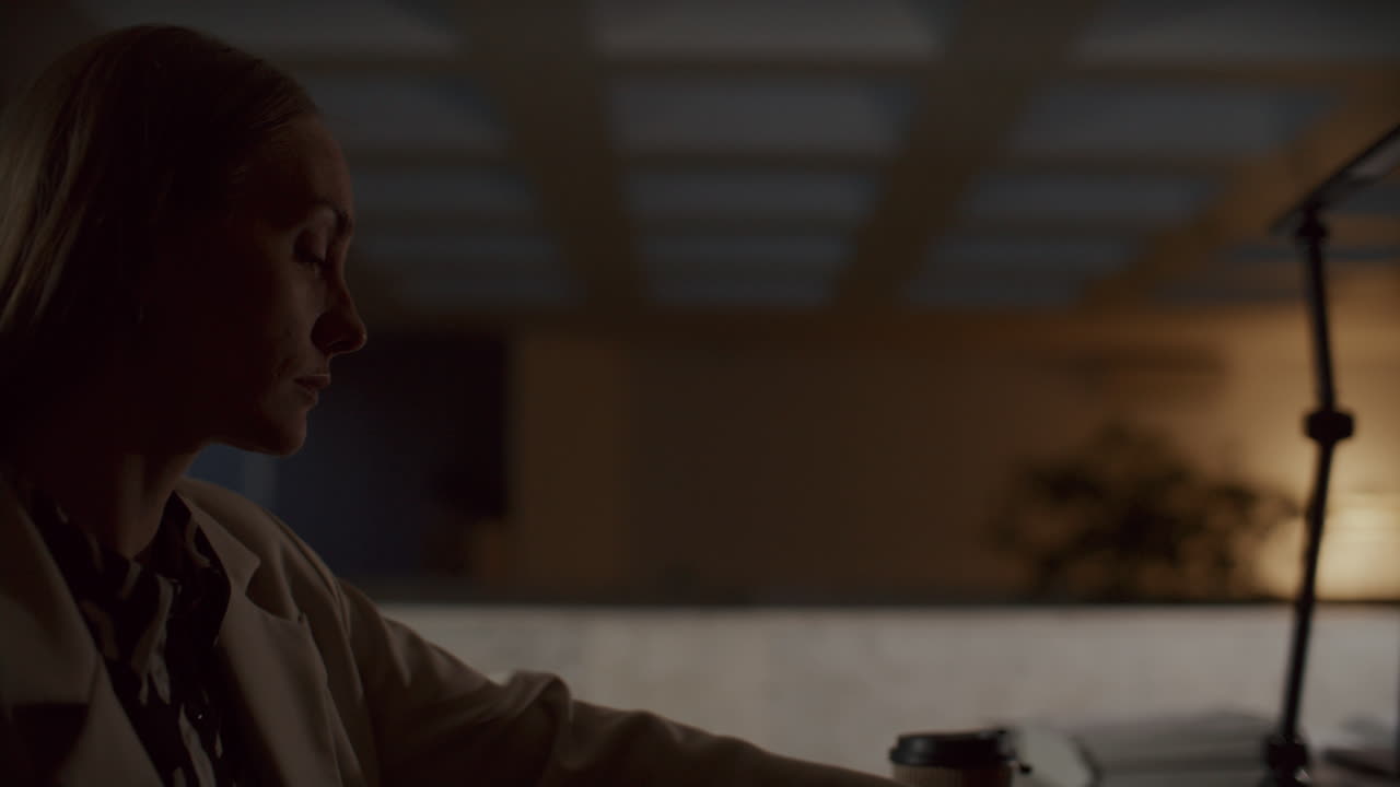 Overworked Businesswoman Closing Laptop and Leaving Office at Night