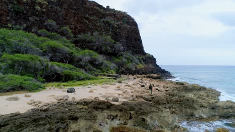 Couple-walking-on-the-rocky-sea-coast-4k