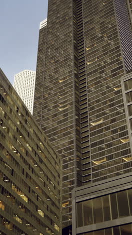 skyscrapers rise against a dusky sky in an urban landscape