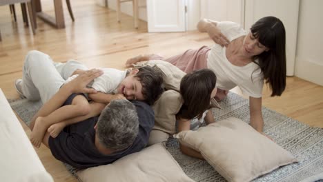 cheerful family with two kids romping